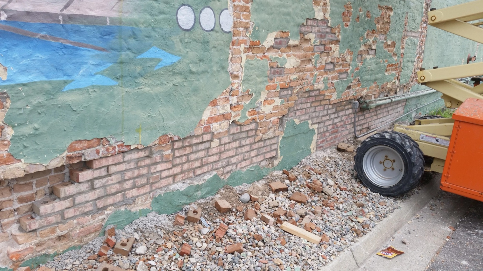 An ICS crew mid-restoration on a masonry building wall